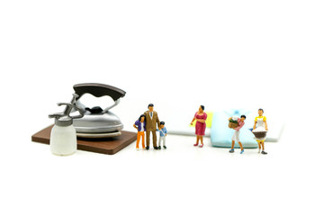 Miniature people : Maid,woman housewife ironing clothes iron in laundry at home.