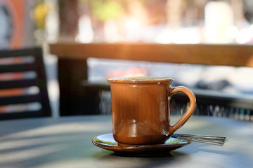 Coffee morning concept, Mug of coffee on table and morning light.