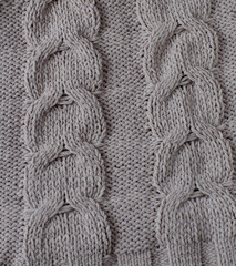 a piece of knitted fabric handmade beige color (braided knitted braids)