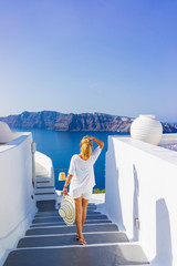 Luxury travel vacation woman looking at view on Santorini island