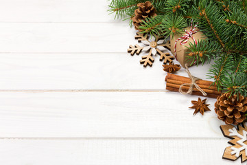 Christmas background with fir tree and gift box on wooden table. Top view with copy space for your design