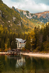 Fototapeta premium a large white building sitting on top of a lake Lago Di Braies, Italy