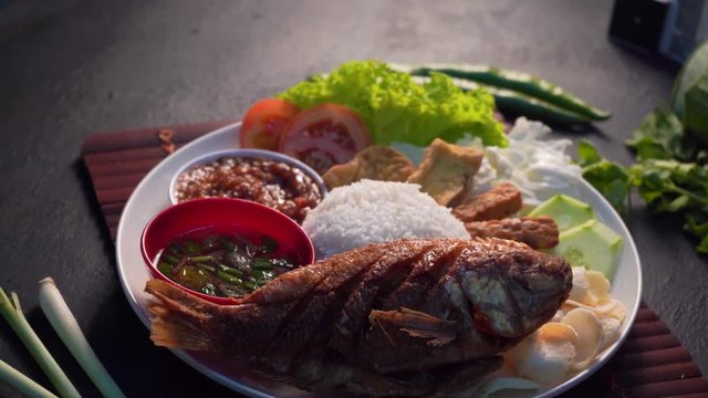 traditional malay dish with deep fried snapper fish