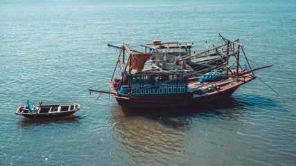 Naklejka na ściany i meble Old fishing boats in the sea in Ha Long Bay. Vietnam