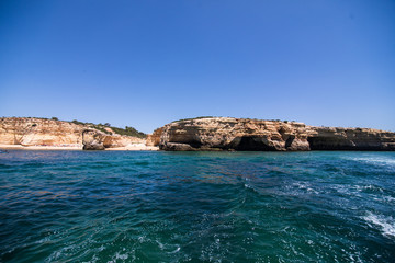 Obraz premium Rocks, cliffs and ocean landscape at coast in AAlgarve, Portugal view from boat