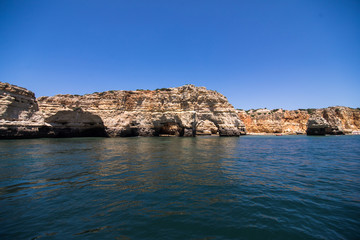 Fototapeta premium Rocks, cliffs and ocean landscape at coast in AAlgarve, Portugal view from boat