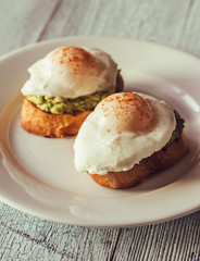 Sandwiches with guacamole and poached eggs