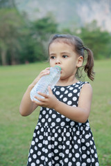 Cute girl drinking water.