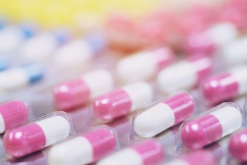 close up pharmaceuticals antibiotics pills medicine in blister packs. colorful antibacterials pills Pharmacy background. capsule pill medicine Antimicrobial drug resistance. Pharmaceutical industry