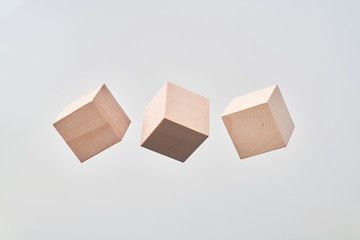 Abstract floating wooden cube on white background