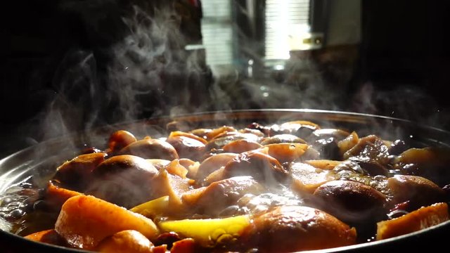 Cooking stewed fruit. Slow motion.	Compote cooks in a pan.