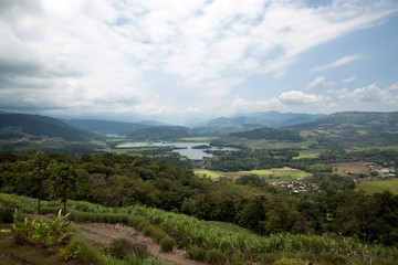 Fototapeta na wymiar View over the beautiful Costa Rican valley of Turrialba and the Angostura Lagoon near the active volcano with same name. 