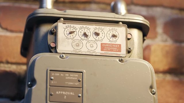 Gas meter showing fuel flow in a timelapse. Camera zooms into a closeup. 4KHD