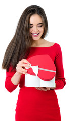 Beautiful happy smiling young woman holding red heart gift box with valentine's present inside, isolated on white background. Valentine's day image.