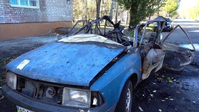 The blown-up car as a result of terrorist attack.	Car after terrorist attack.