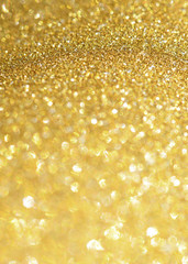 Golden glitter sparkling background. Shiny glam abstract texture. 