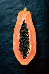 Papaya cross-section on dark slate