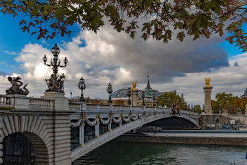 Fototapeta na wymiar The Pont Alexandre III over the seine river is a deck arch bridge that spans the Seine in Paris. It connects the Champs-Élysées quarter with those of the Invalides and Eiffel Tower.