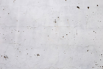 brick plastered wall with whitewash with potholes, cracks and stains, shot on a cloudy autumn day
