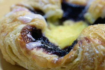 Danish pastry with blueberry and custard. Close up image. Shallow depth of field.