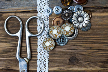 several vintage buttons, lace, and a dressmaker scissors