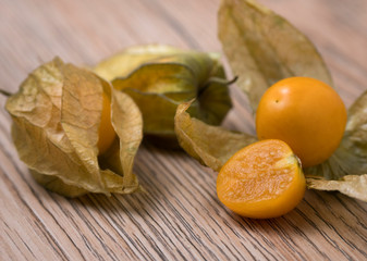 Physalis fruit (Physalis Peruviana) with husk on wooden background.
