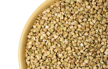Natural fresh green buckwheat in ceramic bowl on white background.