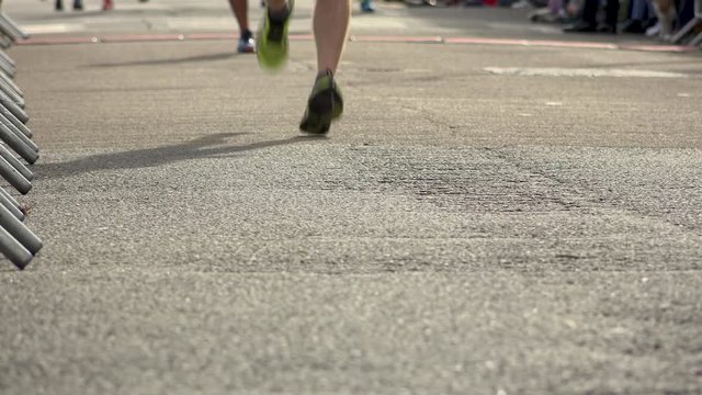 Anonymous shot of runners feet in race speeding past camera