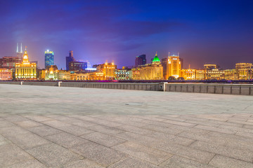 Fototapeta na wymiar Blue sky, empty marble floor and skyline of Shanghai urban architecture.
