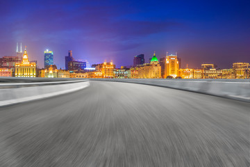 Fototapeta premium Empty asphalt road along modern commercial buildings in China's cities