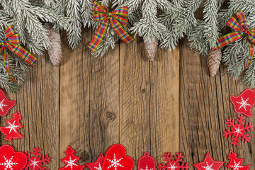 The branch of spruce with a gift on old wooden table.