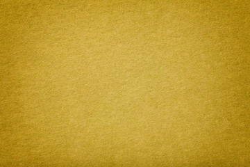 Golden matt suede fabric closeup. Velvet texture.