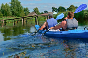 The two rowers in the blue kayak. The rowers in the kayak. The fusion of two rowers.