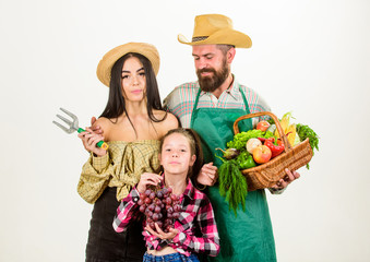 Harvest festival concept. Parents and daughter farmers celebrate harvest holiday. Family rustic style farmers proud of fall harvest. Family farmers gardeners basket harvest isolated white background