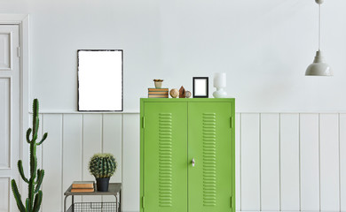 Close up green cabinet with frame and lamp decoration.