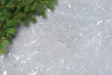 Christmas gray cement background with fir tree and copy space. top view empty space for your design