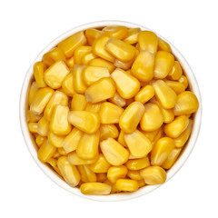 Boiled corn kernels pile / heap in bowl from top view isolated on white background.