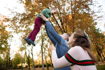 Happy family resting in beautiful autumn park