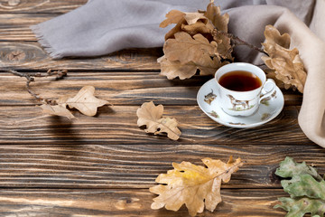 cup of tea and leafs on wooden table