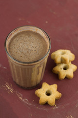 top view hot sweet homemade cocoa and cookies in a shape of stars on a brown shabby wooden table