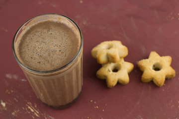 top view hot sweet homemade cocoa and cookies in a shape of stars on a brown shabby wooden table
