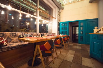 empty room interior in blue and orange colors, served table and chairs