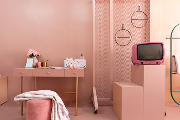 Working corner with white and multicolor pebbles terazzo cabinet on baby pink working top with old rose painted wall in the background / interior design concept / interior for advertising
