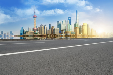 Empty asphalt road along modern commercial buildings in China's cities