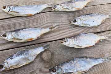 Dried fish on rustic wooden table. Top view