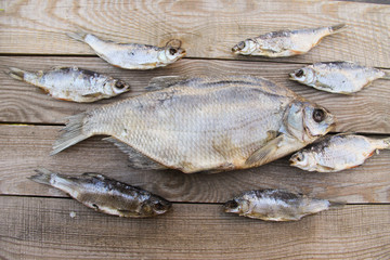Dried fish on rustic wooden table. Top view