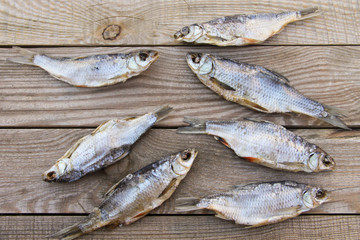 Dried fish on rustic wooden table. Top view