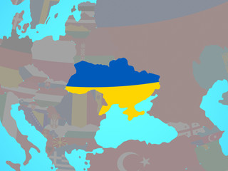 Ukraine with national flag on blue political globe.