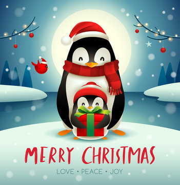 Adult penguin and baby penguin under the moonlight in Christmas snow scene.