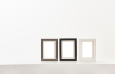 Three frame on the white table and white wall style.